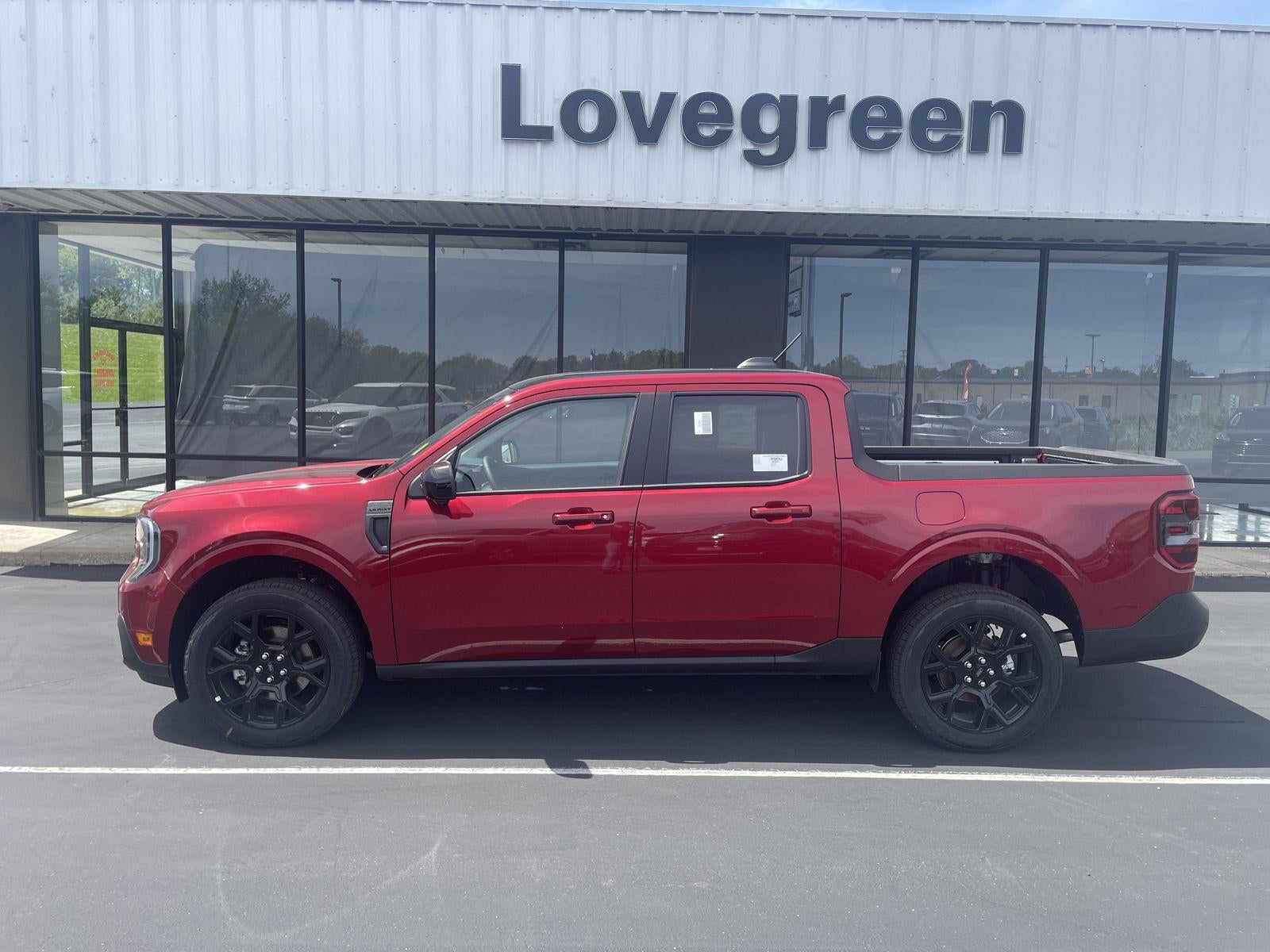 2026 Ford Maverick LARIAT in Ruby Red Metallic Tinted Clearcoat — front three-quarter view