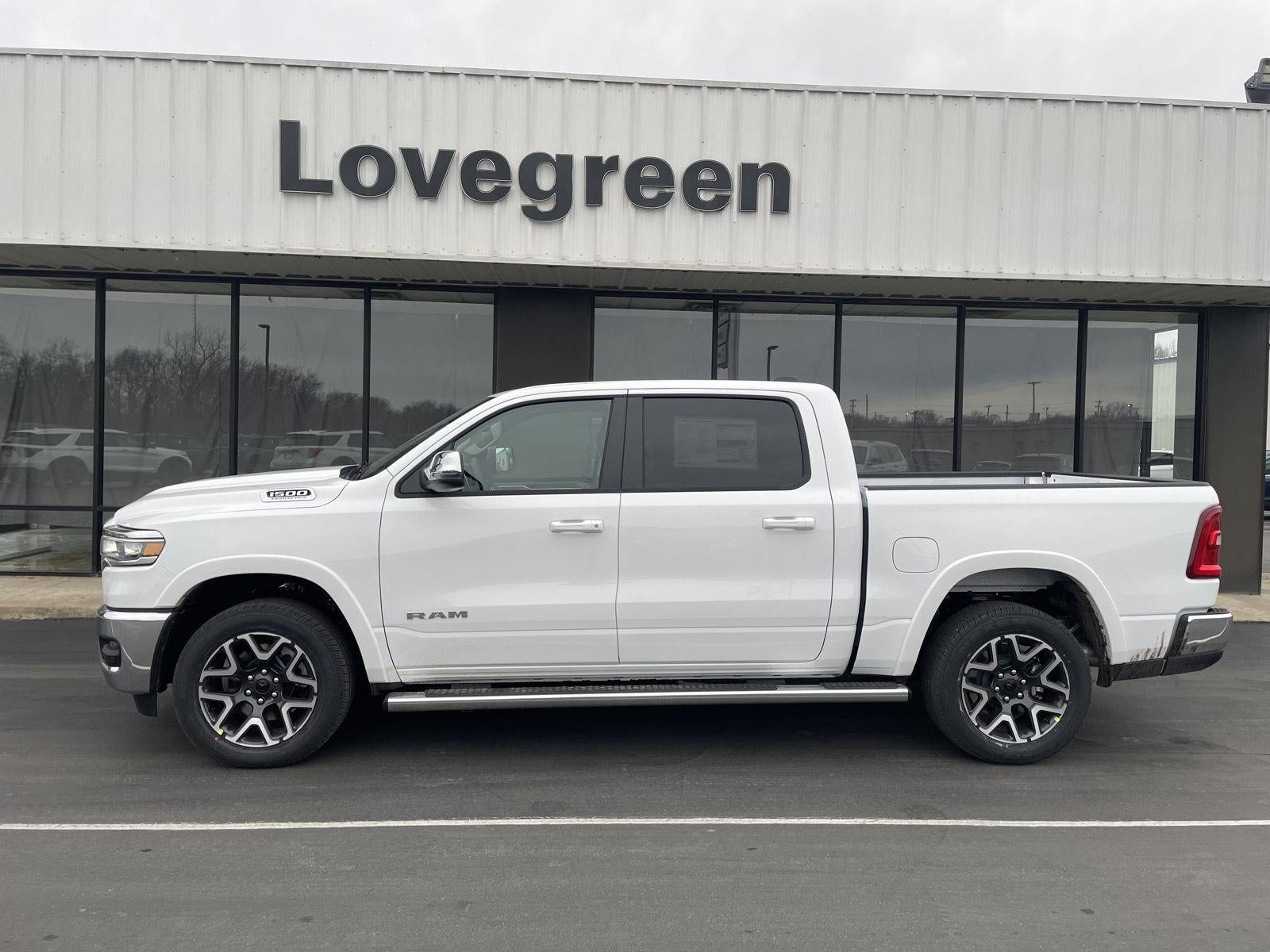 2026 RAM Ram 1500 RAM 1500 LARAMIE CREW CAB 4X4 5'7' BOX in Bright White Clear-Coat Exterior Paint — front three-quarter view
