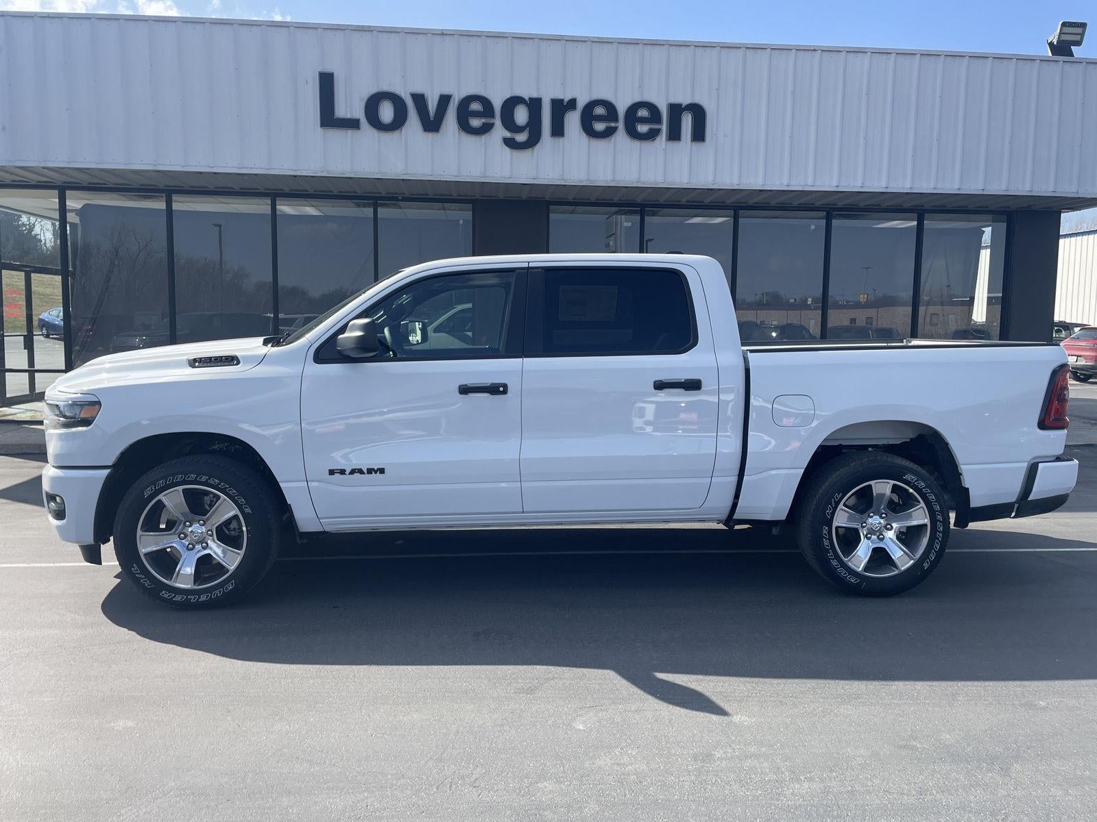 2026 RAM Ram 1500 RAM 1500 EXPRESS CREW CAB 4X4 5'7' BOX in Bright White Clear-Coat Exterior Paint — front three-quarter view