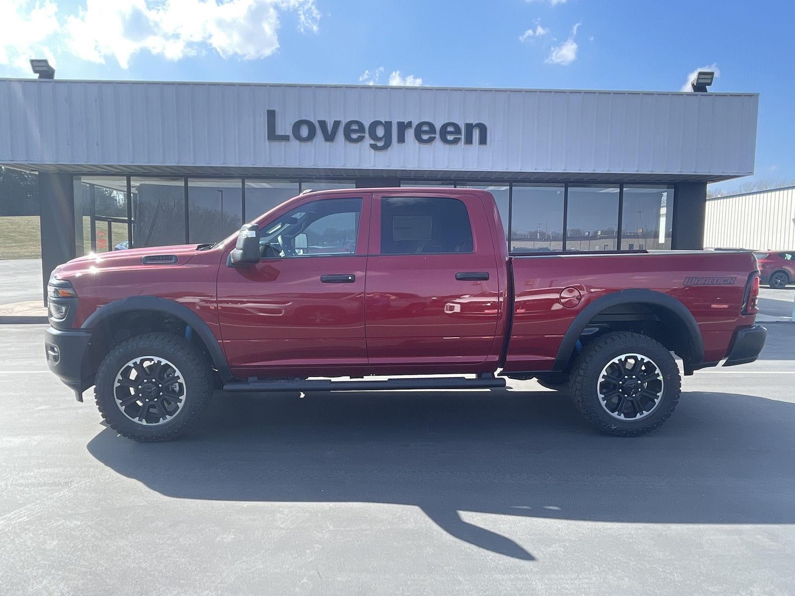 2026 RAM Ram 2500 RAM 2500 WARLOCK CREW CAB 4X4 6'4' BOX in Molten Red Pearl-Coat Exterior Paint — front three-quarter view